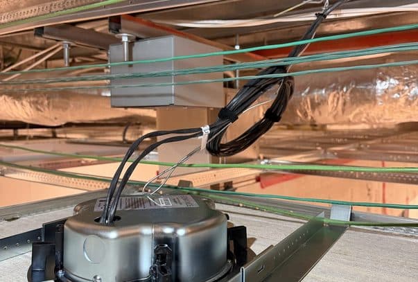 Bundles of network cable supported on J-hooks above a commercial ceiling grid