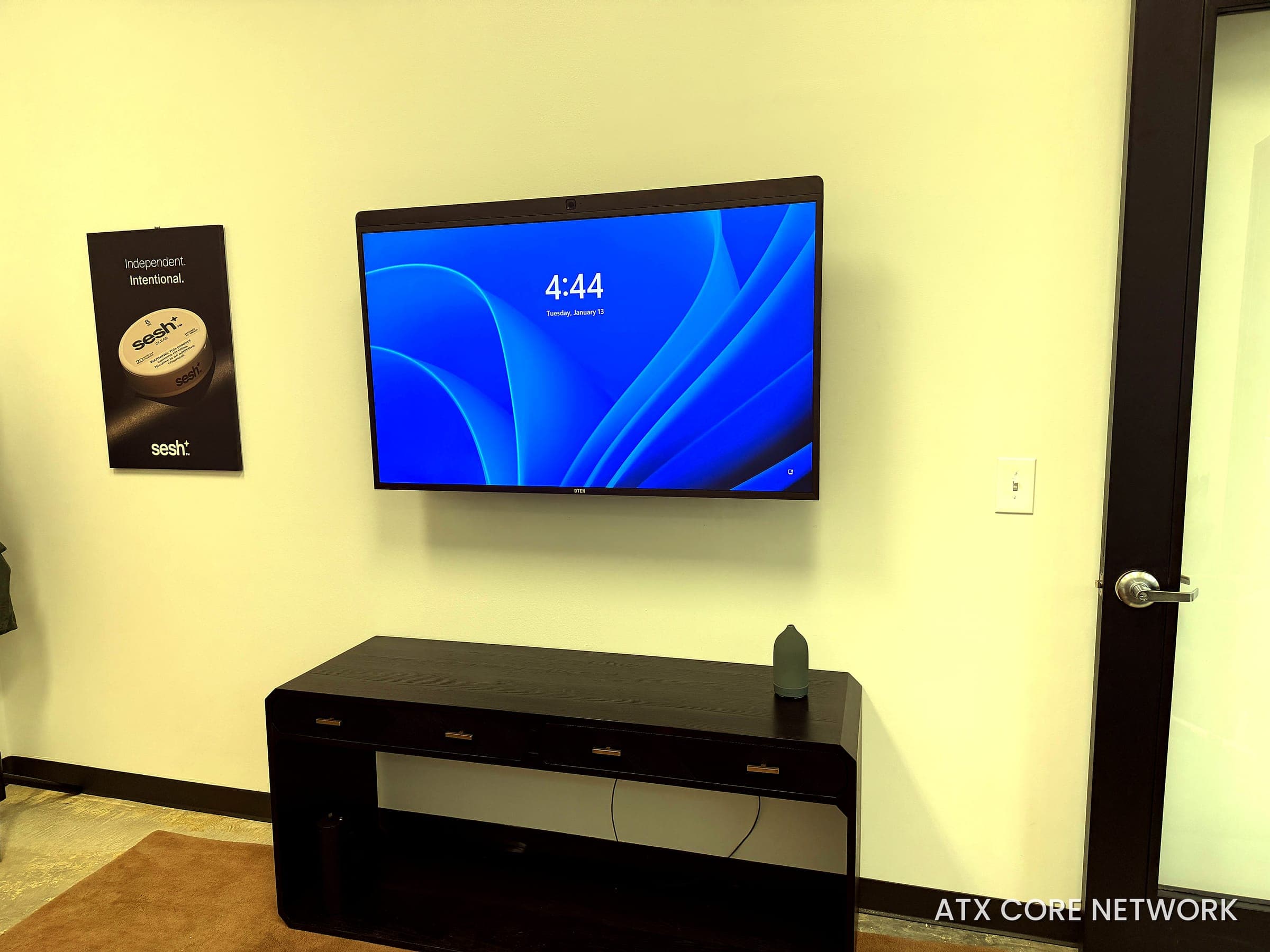 Wall-mounted video conferencing display with concealed wiring