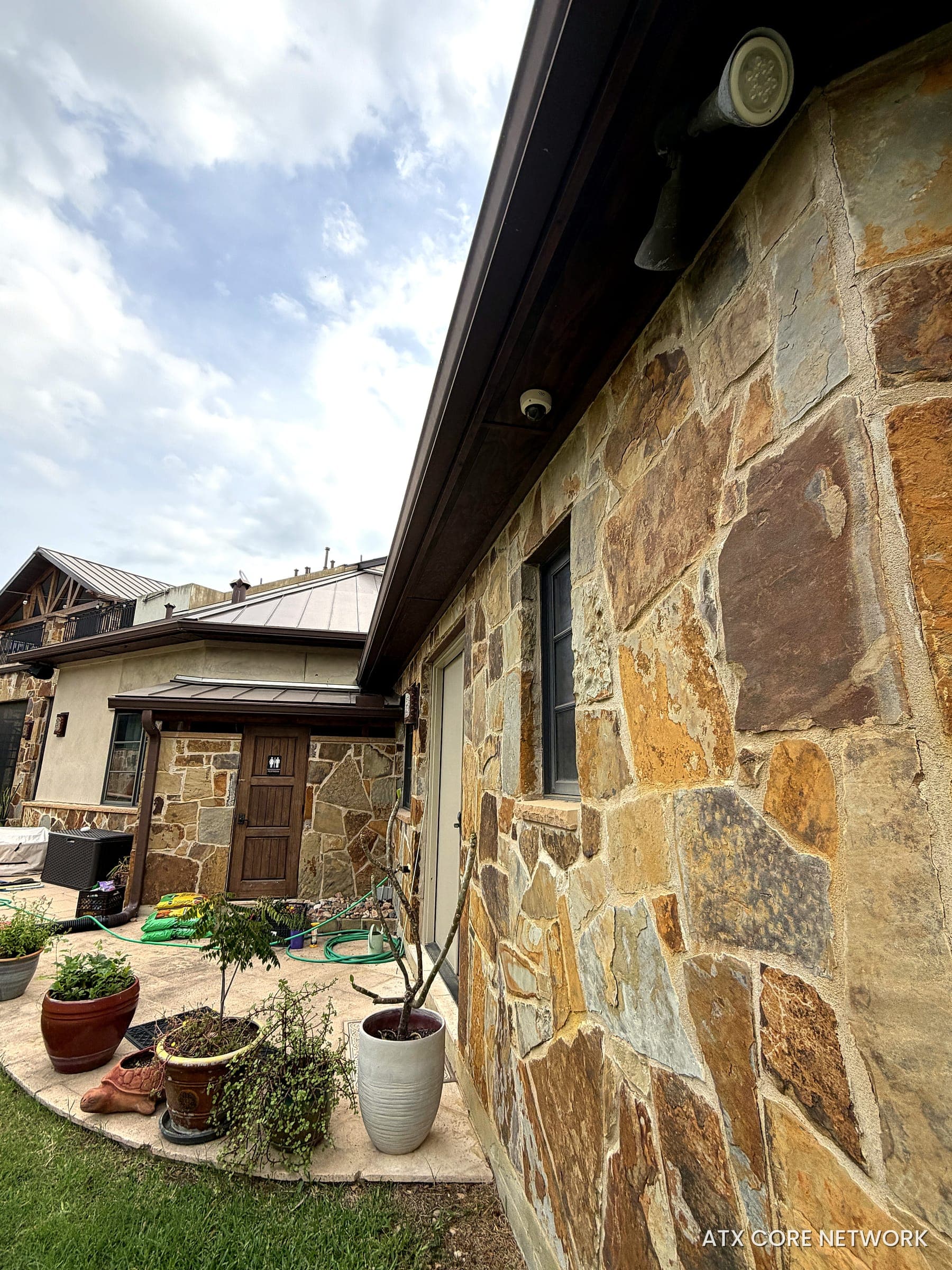 Dome IP camera covering a stone patio and backyard