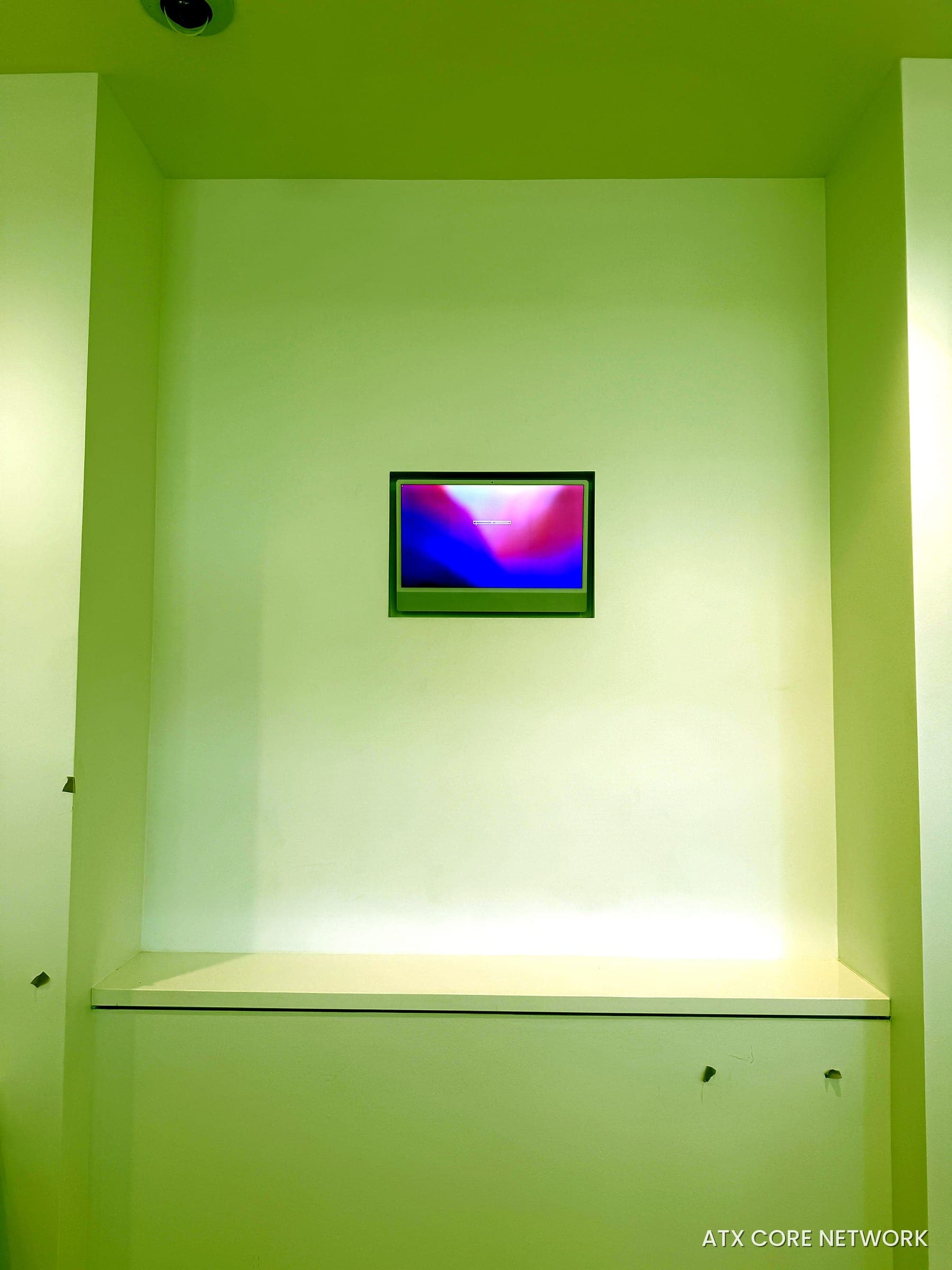 In-wall mounted display in a custom niche with a ceiling camera above