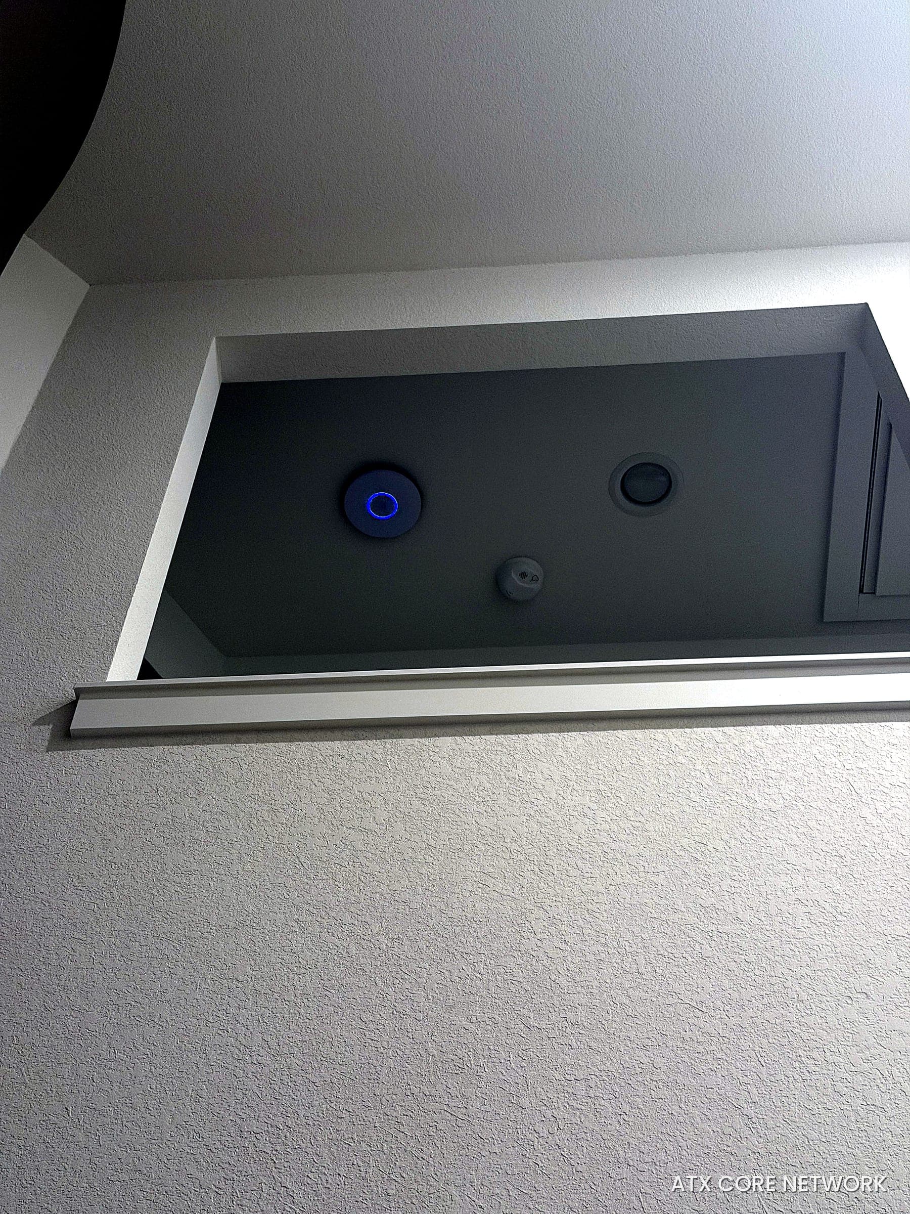 Wi-Fi access point and in-ceiling speaker on a vaulted ceiling